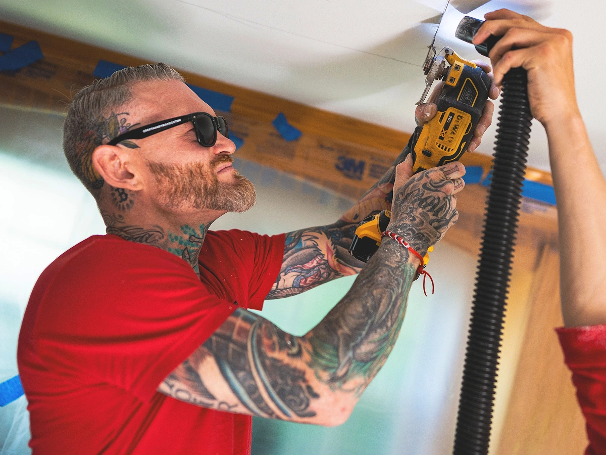 A man cutting drywall.