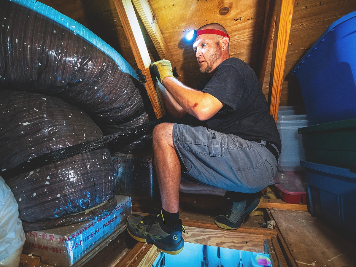 A man wearing a headlight and gloves.