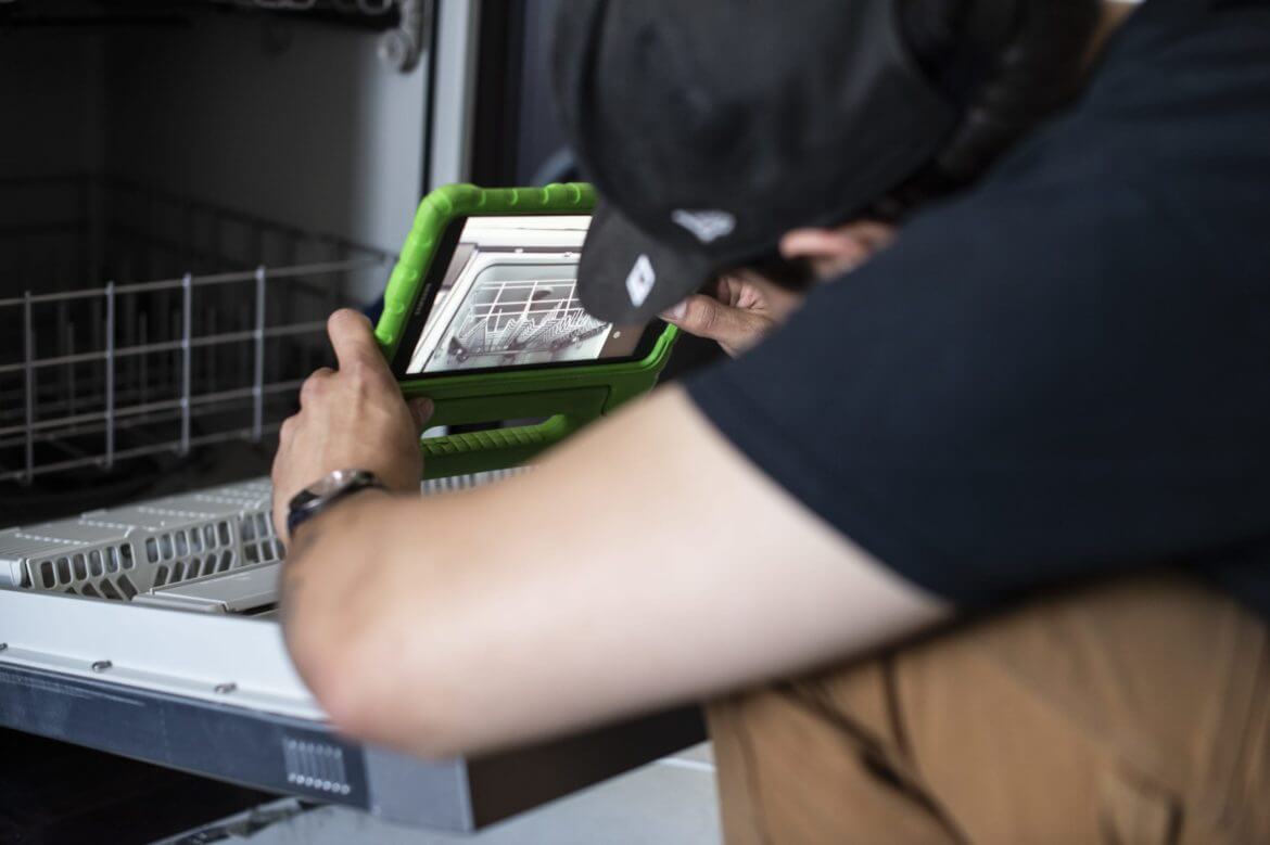 Technician using appliance repair apps