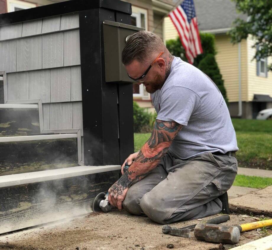 image of Ryaan Tuttle working on front steps