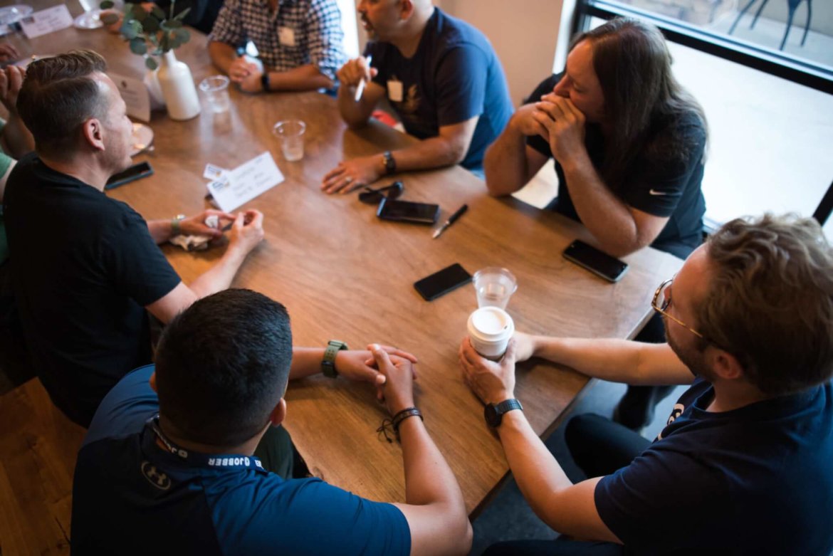 Construction workers in a meeting, determining profit margins