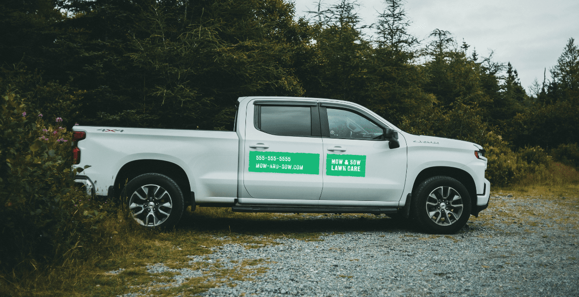 lawn care advertising examples - truck wrap with logo, phone number, and website URL on white pickup truck